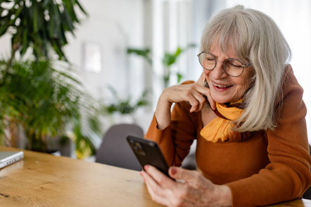 istock Senior Woman Embracing Technology at Home 2158234032