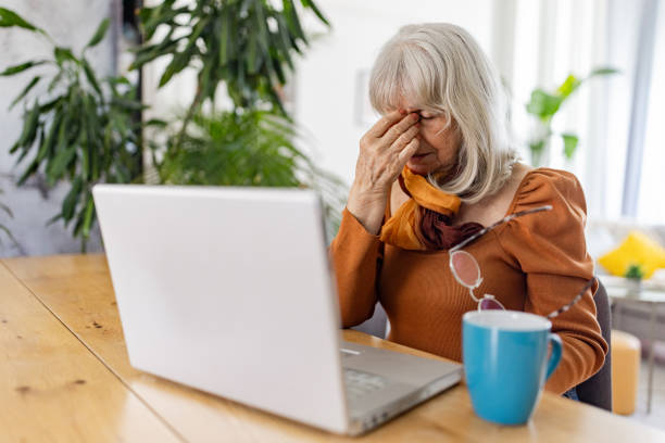 istock Senior Woman tired from using laptop 2158234595