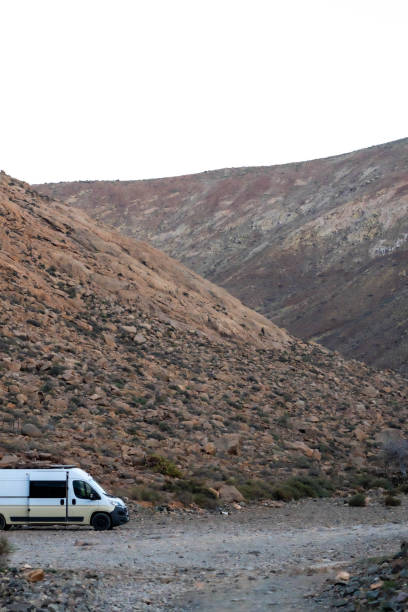 istock Solitary Camper Van in the Rugged Mountains at Dusk 2158234643