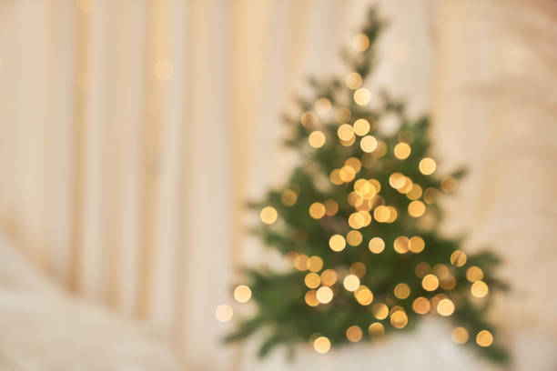 istock Festive magic. Blurred background with Christmas tree on beige background with space to copy 2158234732