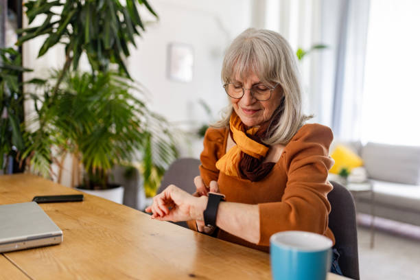 istock Senior Woman Embracing Technology with Smartwatch 2158234805