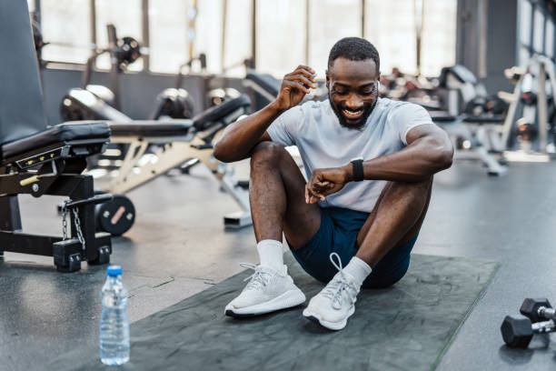 istock Man resting in gym with water bottle 2158235690