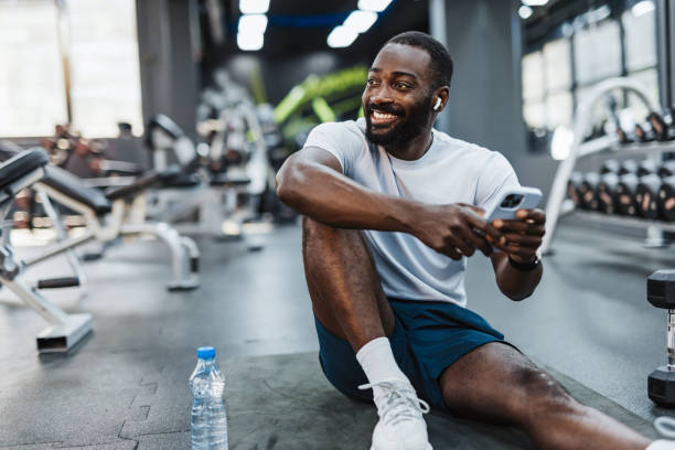 istock Man resting with smartphone in gym 2158235734