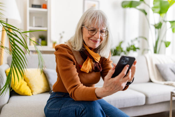 istock Senior Woman Embracing Technology at Home 2158235843