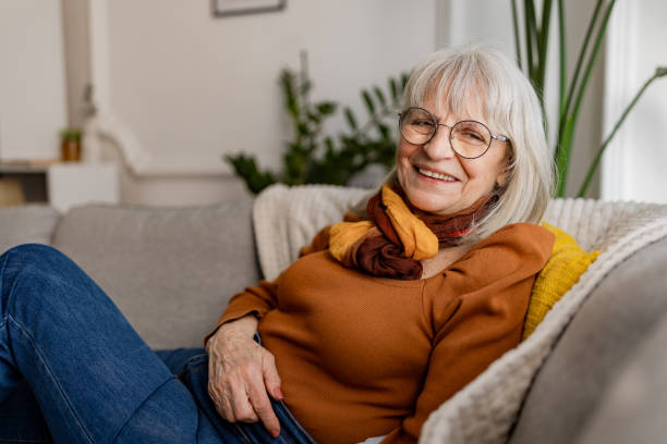 istock Charming Senior Woman Relaxing on Sofa 2158236323