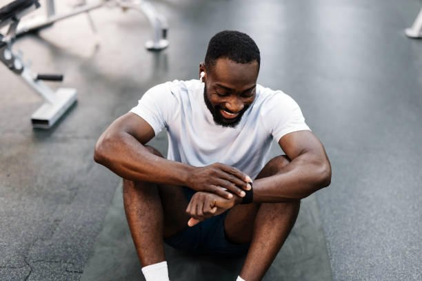 istock Resting athlete sitting on gym floor 2158236476