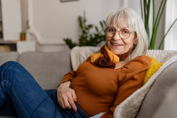 istock Charming Senior Woman Relaxing on Sofa 2158236494