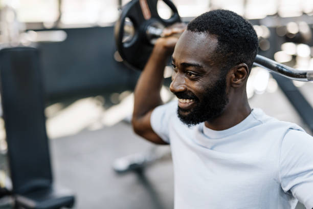 istock Individual exercising with a weight bar 2158236546