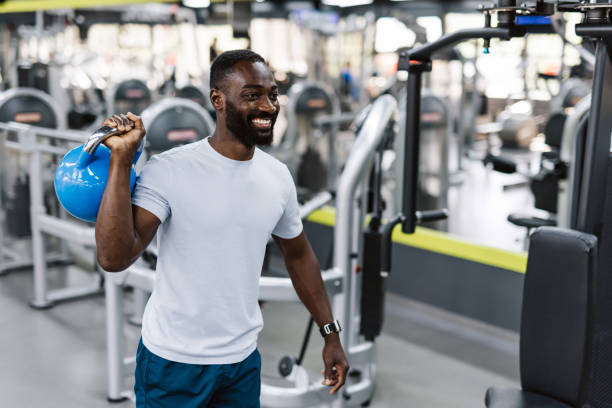 istock Athlete stretching with kettlebell in gym 2158236646