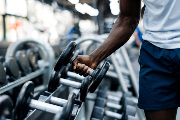 istock Hand taking a dumbbell from weight rack 2158236766