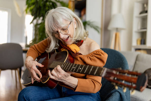Charming Senior Woman Playing Acoustic Guitar