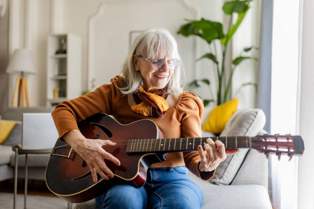 istock Charming Senior Woman Playing Acoustic Guitar 2158238202
