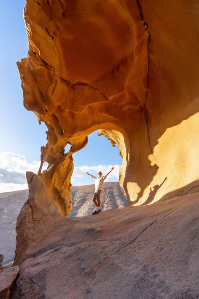 istock Joyful Hiker Celebrating Under Arco De Las Penitas at Sunset 2158240473