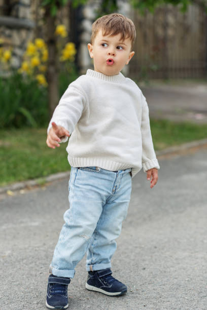 istock Curious toddler pointing and exploring outdoors 2158240483