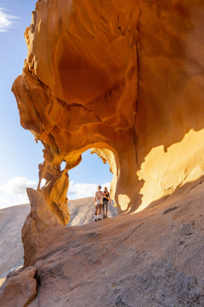 istock Adventurous Hikers Exploring Arco De Las Penitas in Golden Afternoon Light 2158240605