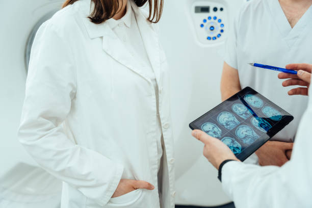 istock A doctor is looking at a computer screen with a picture of a brain on it 2158242310