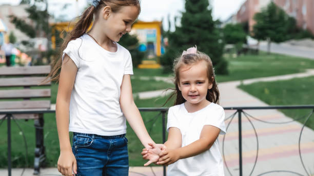 istock Two cute little girls having fun on a playground outdoors in summer 2158244721