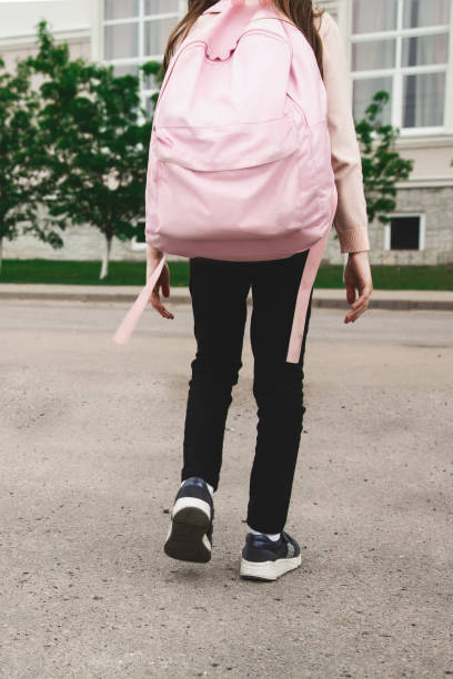 istock Little girl with backpack going to school, back view. Back to school 2158244952