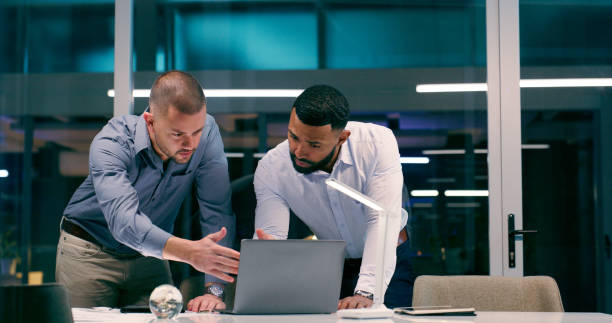 istock Men, review and laptop in workplace together for teamwork, collaboration and partnership with strategy. Detectives, technology and investigation for justice, corruption and crime with video evidence 2158245543