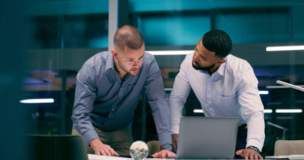 istock Men, laptop and review in workplace together for teamwork, collaboration and partnership with strategy. Detective, technology and investigation for justice, corruption and crime with video evidence 2158245544