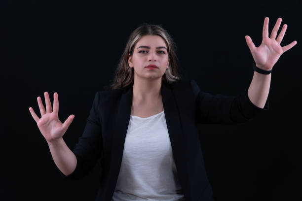 istock Woman using the virtual reality headset. Nice young woman using transparent screen, Technology concept. Black background. 2158246127