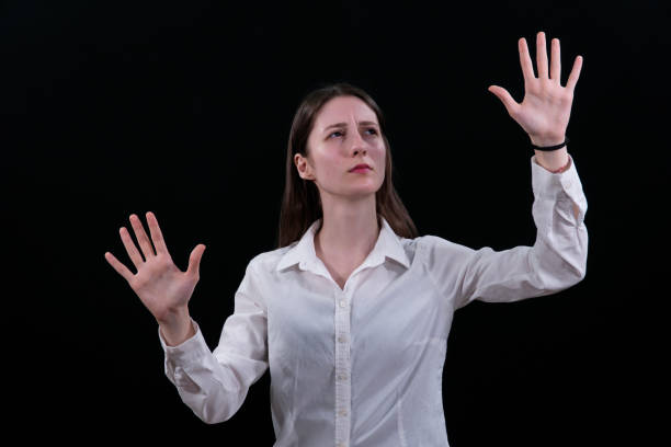 istock Woman using the virtual reality headset. Nice young woman using transparent screen, Technology concept. Black background. 2158247946