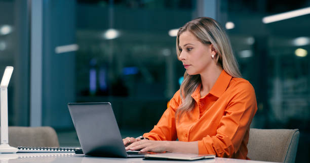 istock Woman, typing and laptop at night office with ideas, planning and article script of late breaking news web. Serious, female person and research, information and project deadline as reporter agenda 2158254609