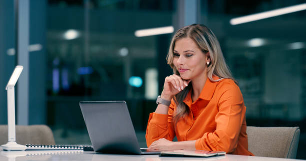 istock Thinking, business and woman on laptop at night office, ideas and planning article script of late breaking news. Serious, female person and research, information and project deadline as reporter 2158254614