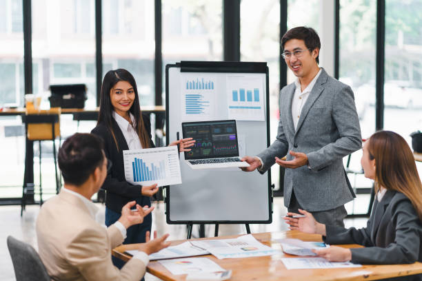 istock Professional diverse business team presenting and discussing data charts and graphs during meeting in modern office. 2158254645