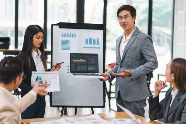 istock Professional diverse business team presenting and discussing data charts and graphs during meeting in modern office. 2158254646