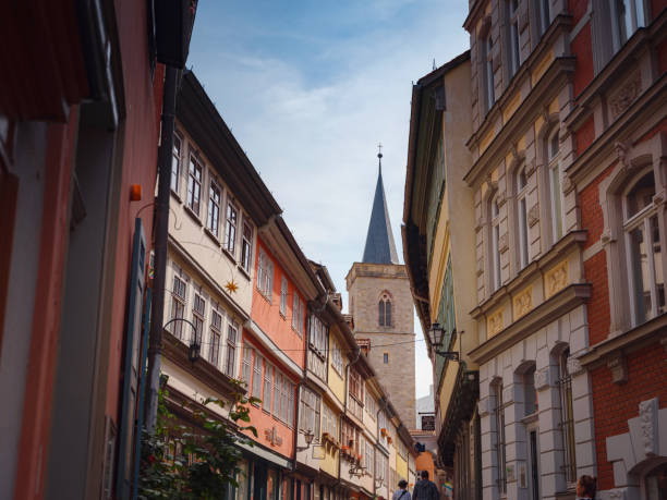 Erfurt, Germany - May 22, 2023: alley on Merchants Bridge, Kraemerbruecke in Erfurt, Germany. It was built in 1325. The only bridge north of the Alps that is built over entirely with houses