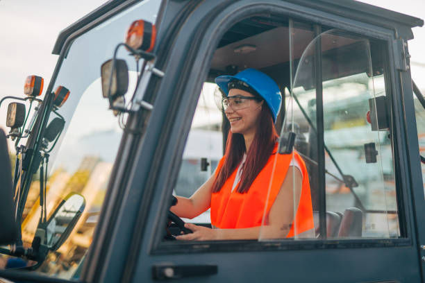 istock female worker drive drive forklift in warehouse 2158255026
