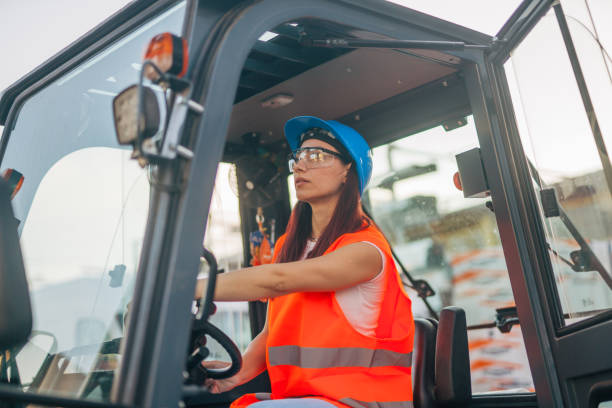 istock female worker drive drive forklift in warehouse 2158255142
