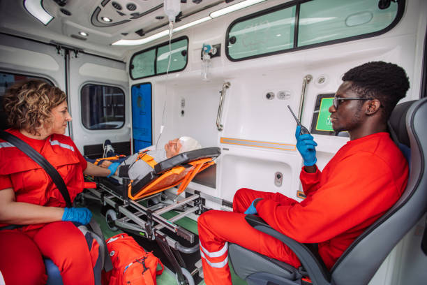 istock Two paramedics sitting with a patient in an ambulance 2158255340