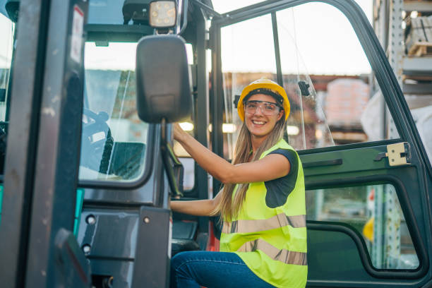 istock female worker drive drive forklift in warehouse 2158255474