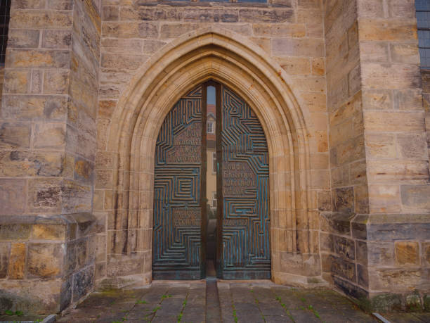 Roskilde, Denmark - April 17, 2025: Side entrance the Roskilde Cathedral a UNESCO World Heritage Site. It was built around 1200 AD. It underwent various extensions, with added chapels. It is the burial church for most Danish kings and queens