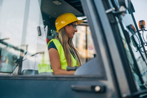 istock female worker drive drive forklift in warehouse 2158256527