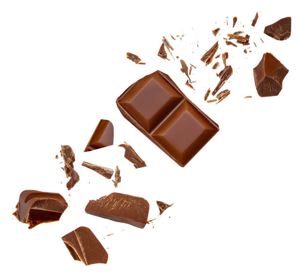istock Explosion  of milk chocolate bar pieces isolated on white background. Pattern.  Crumbs, shavings and Flying Chocolate chunks Top view. Flat lay 2158256531