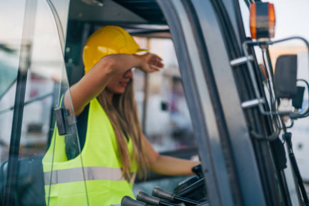 istock tired female worker drive forklift in warehouse 2158256539