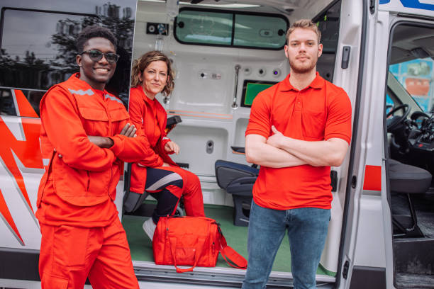 istock Paramedics team posing in front of ambulance 2158257320