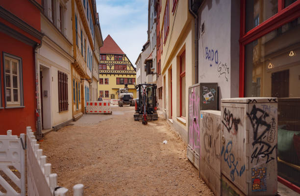 A scenic street corner in Regensburg, Bavaria, Germany, showcasing a historic ivy-covered building with outdoor seating, capturing the charm and tranquility of the area.