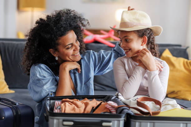 istock Mother and daughter packing for a holiday trip 2158259039