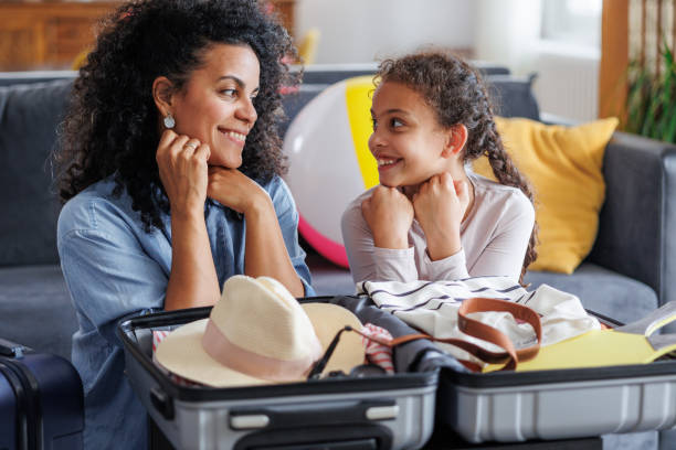 istock Mother and daughter packing suitcase for summer vacation 2158259053