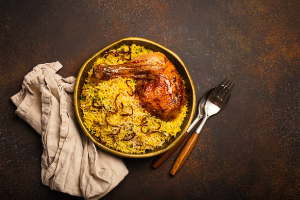 istock Indian dish Biryani chicken with basmati rice in metal brass old bowl on table 2158265796