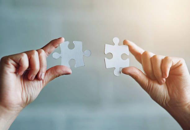 istock Hands, puzzle and connection with teamwork for support or business partner with merger. Collaboration, synergy and unity with link for people or problem solving in workplace, innovation and closeup 2158266059