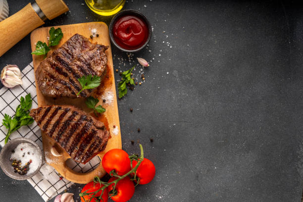 istock Grilled beef steak on wooden cutting board 2158266285