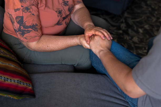 istock Mother and Son Holding Hands on Couch 2158267617