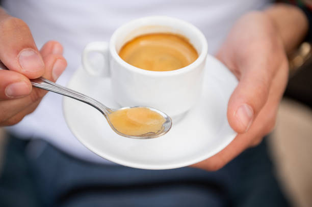 Person holding espresso cup and saucer close up