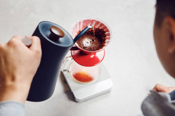 istock Brewing Perfect Cup: Pour Over Coffee Preparation With V60 Funnel on Kitchen Counter 2158268863