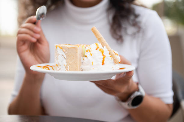 Woman enjoying dessert with whipped cream and caramel drizzle